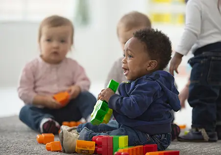 Infant holding toys