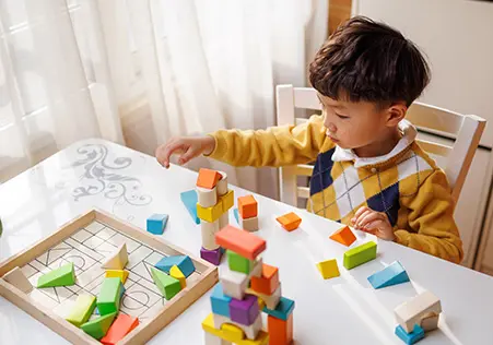 Preschool aged boy playing with blocks