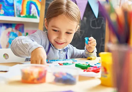 Preschool aged girl doing arts and crafts