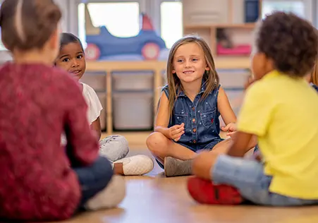 Preschool aged children in circle chating